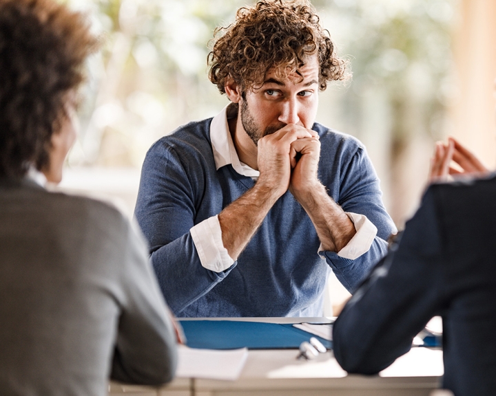 Man in meeting feeling anxious