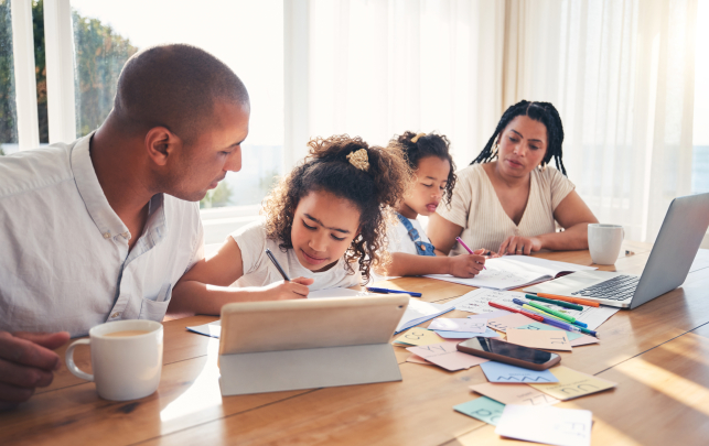 Family doing homework together at table